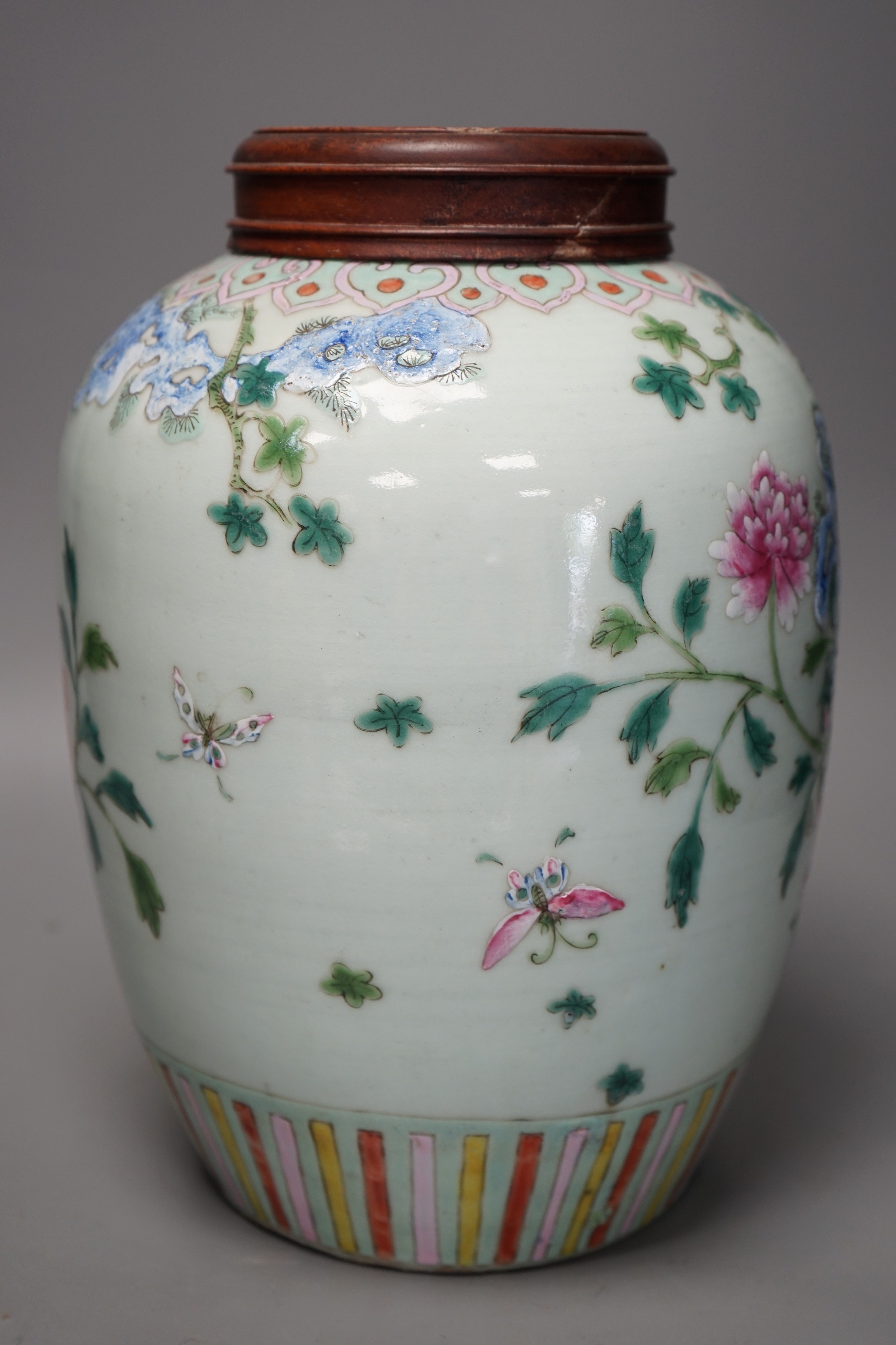 A 19th century Chinese famille rose 'phoenix' jar with wood cover, 30cm tall